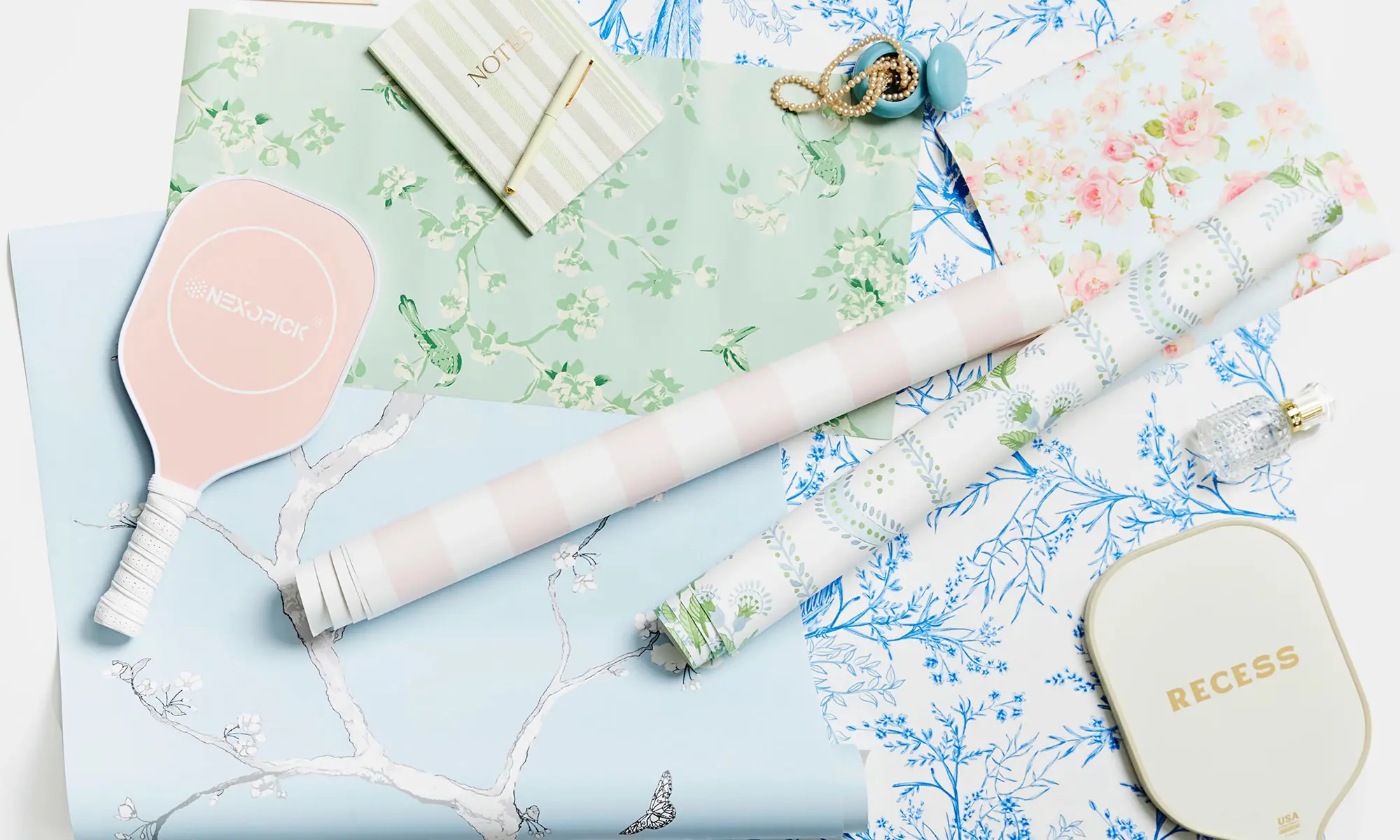 Preppy green, pink and blue wallpaper swatches styled together.