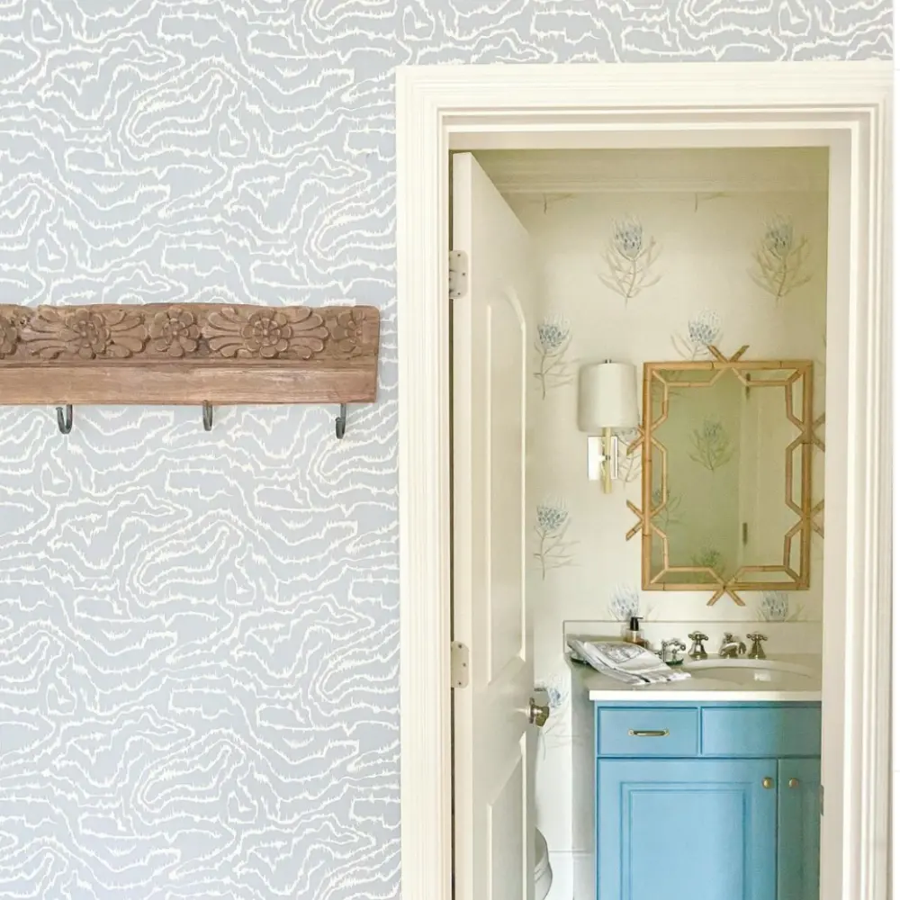 hallway and bathroom with blue wallpaper