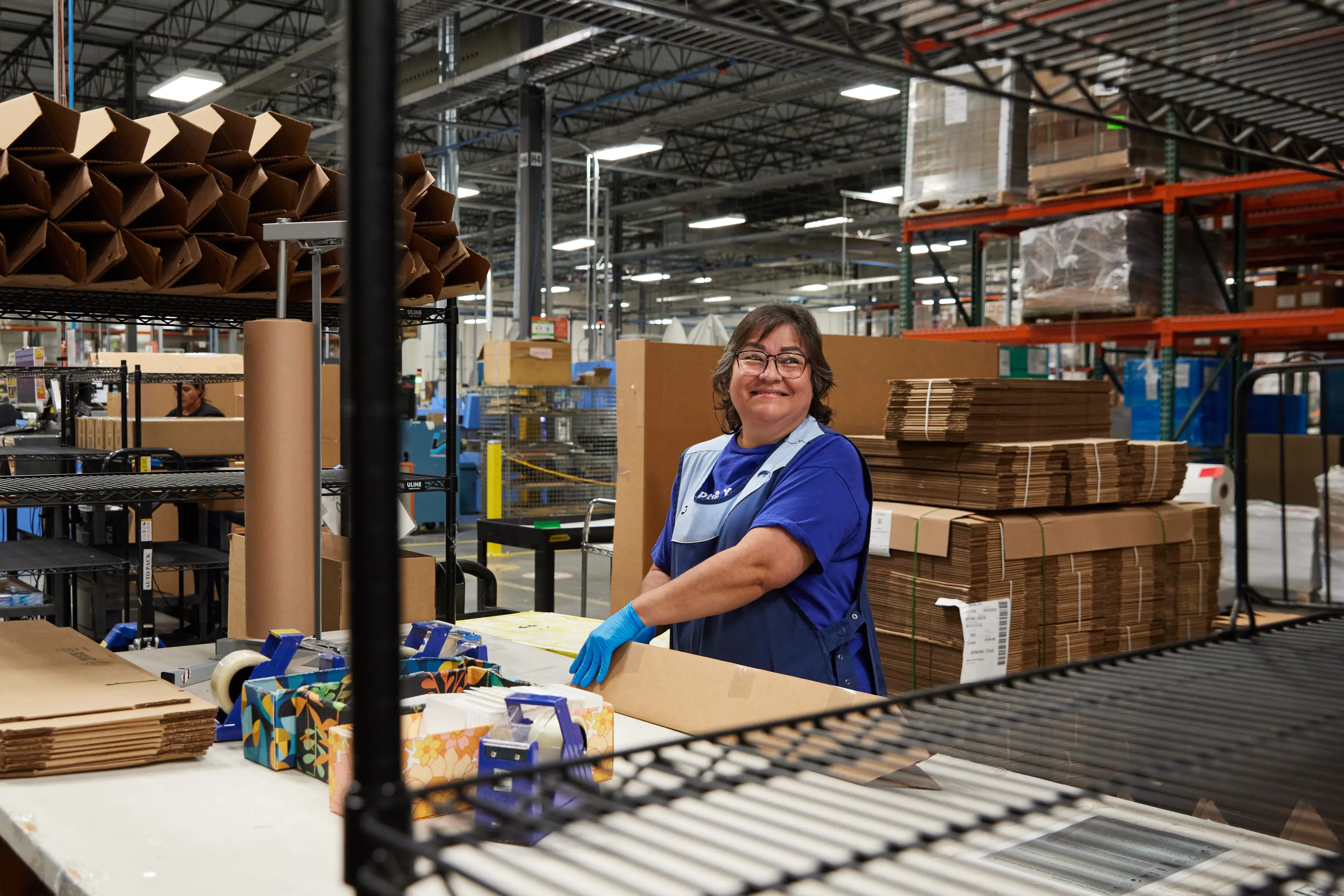 Spoonflower employee packaging an order