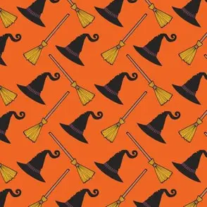 Witch hats and brooms on orange