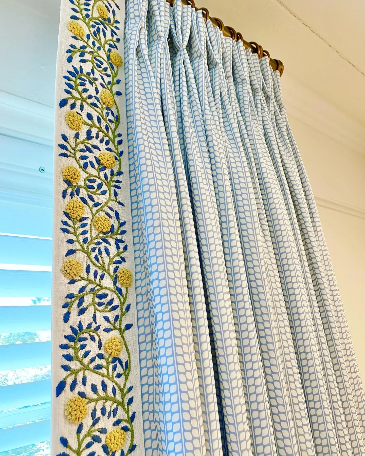 Custom curtain panels with blue and yellow trim